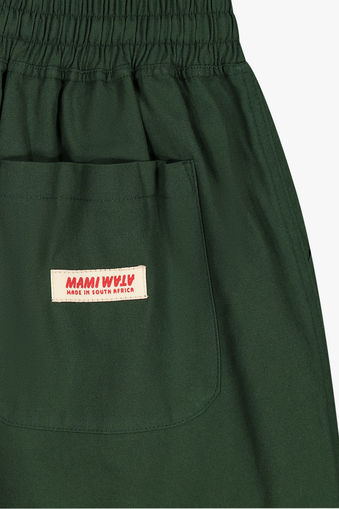 Close-up of cotton twill shorts with MW logo and woven back label.